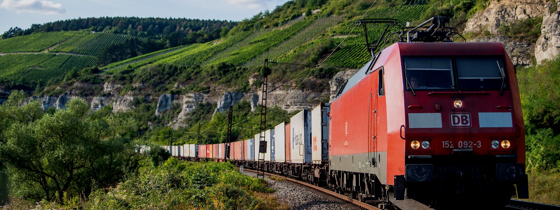Cargo train in front of Swiss wine region. 