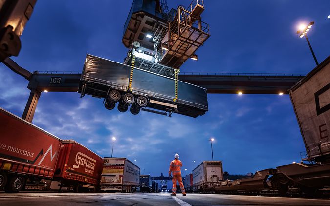 A trailer is craned at night